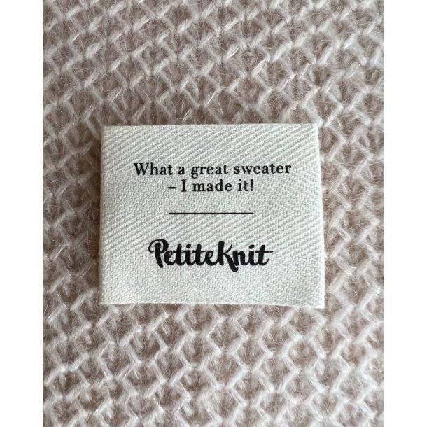 Tekstillabel med teksten "What a great sweater - I made it!". 